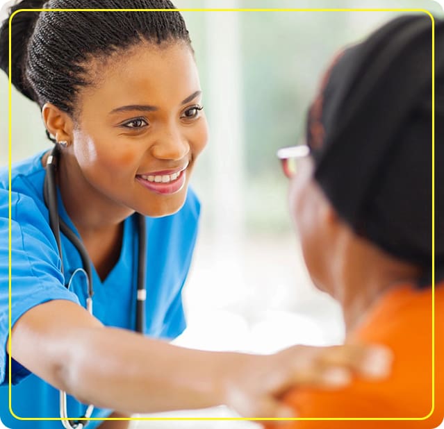 A woman in scrubs is smiling at someone.